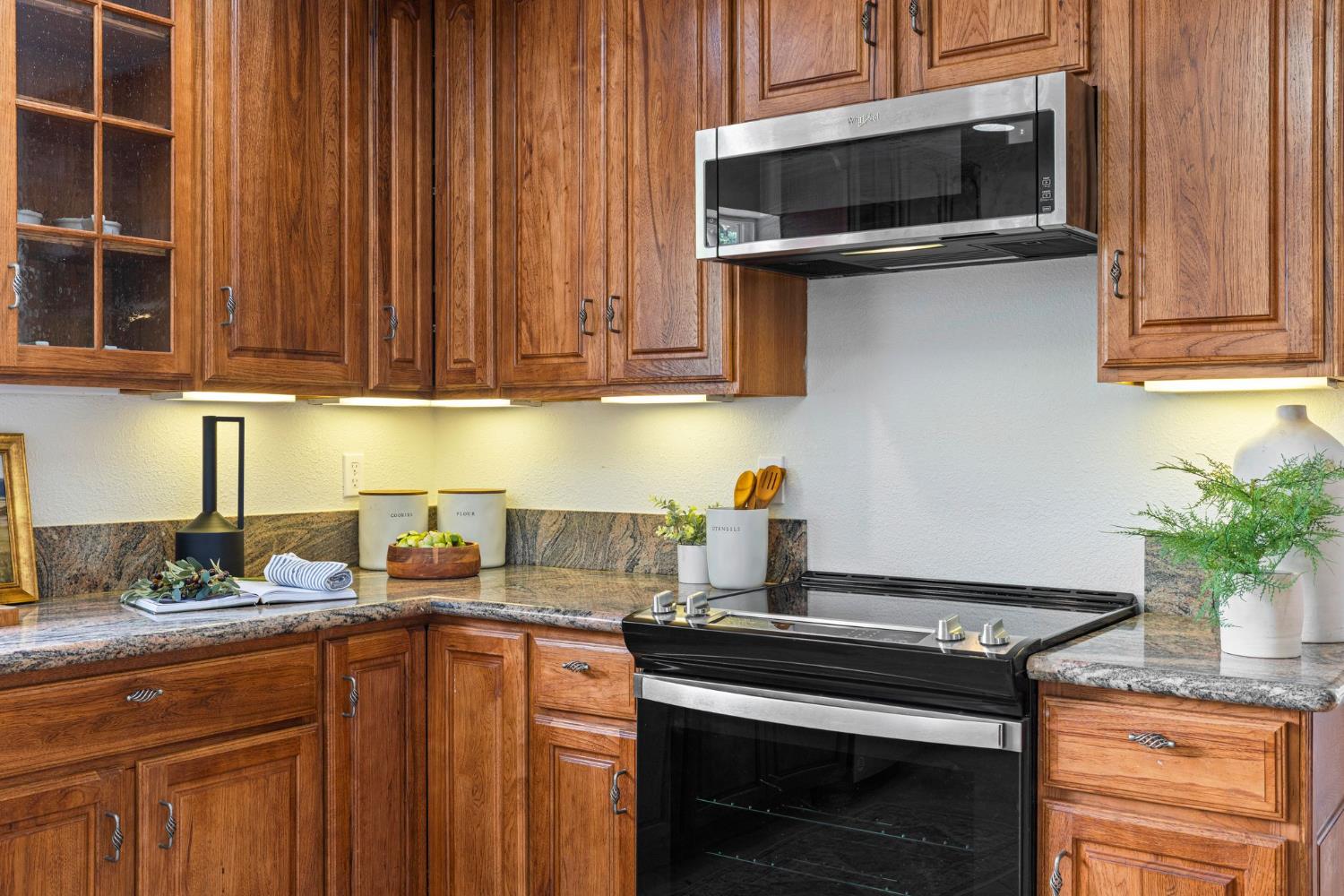 22160 Winchester Way Colfax, CA 95713 - Photo 13 of 84 a kitchen with stainless steel appliances a stove a microwave and sink
