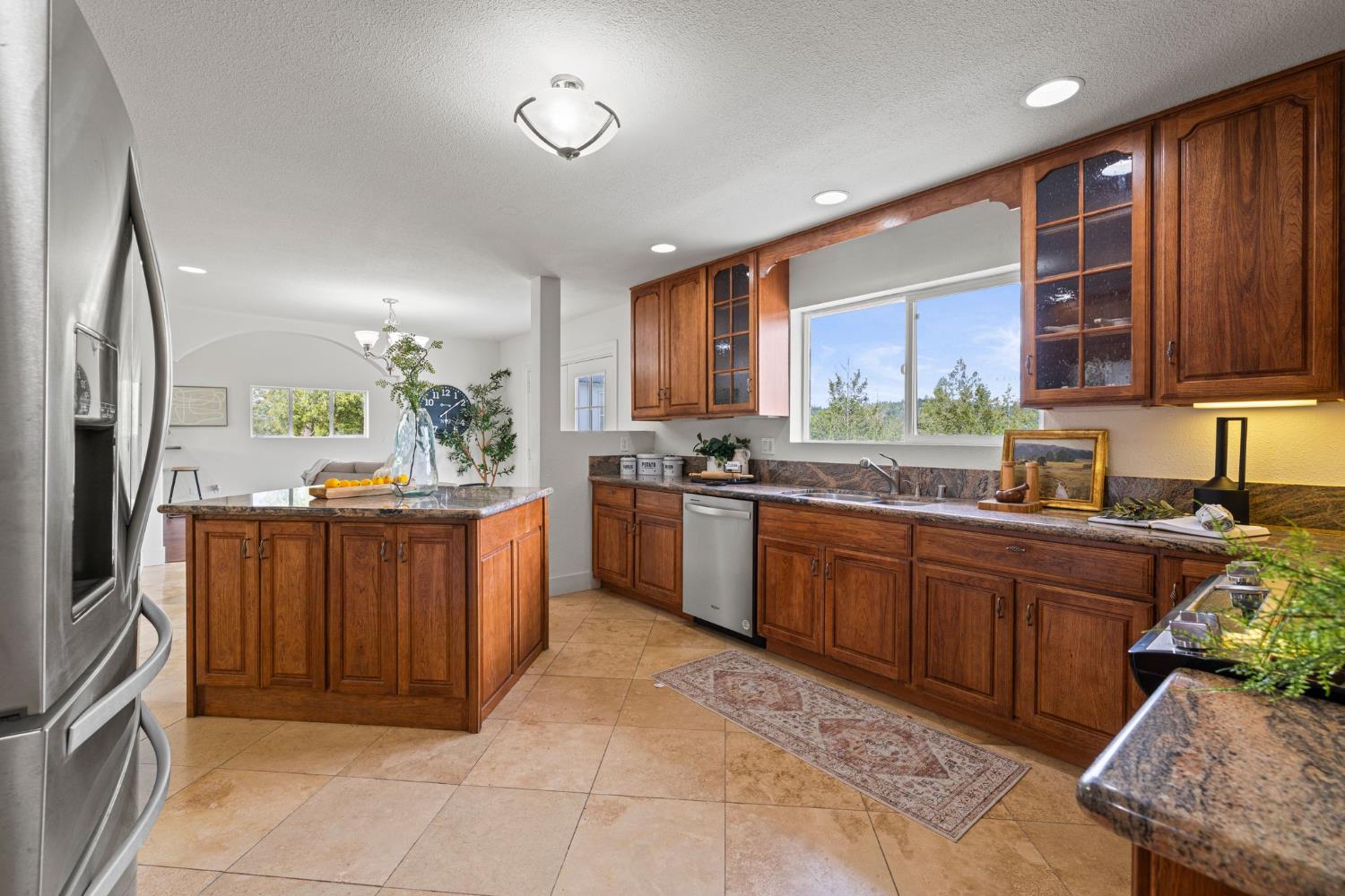22160 Winchester Way Colfax, CA 95713 - Photo 16 of 84 a kitchen with stainless steel appliances granite countertop a stove a sink dishwasher and a refrigerator