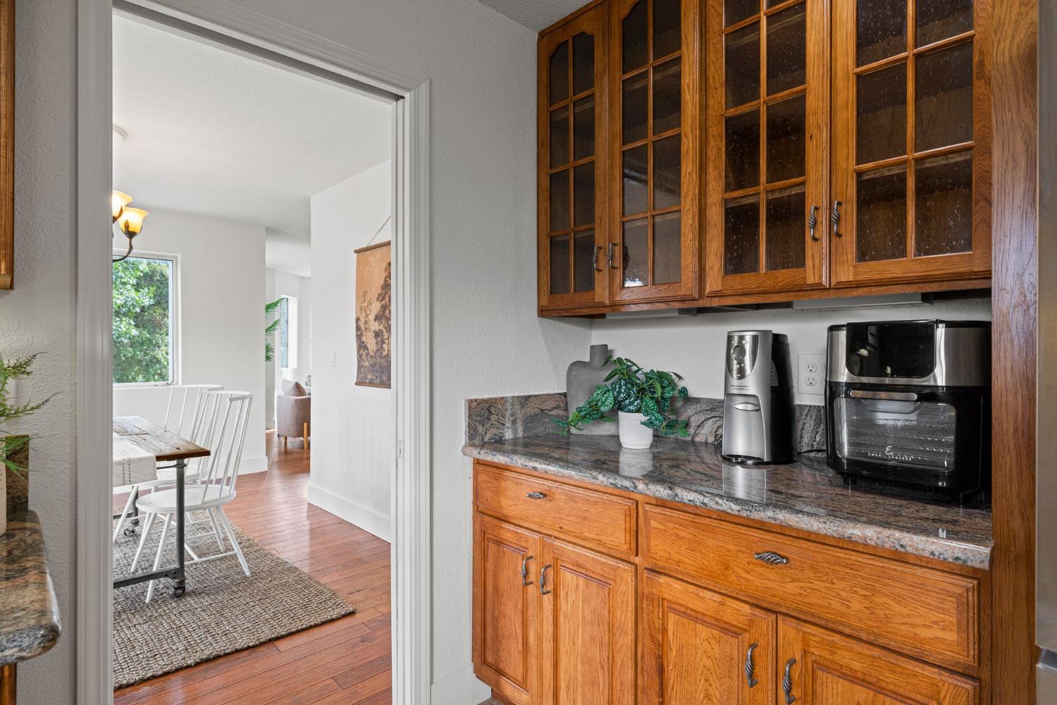 22160 Winchester Way Colfax, CA 95713 - Photo 18 of 84 a kitchen with granite countertop a refrigerator a stove a sink and dishwasher with wooden floor