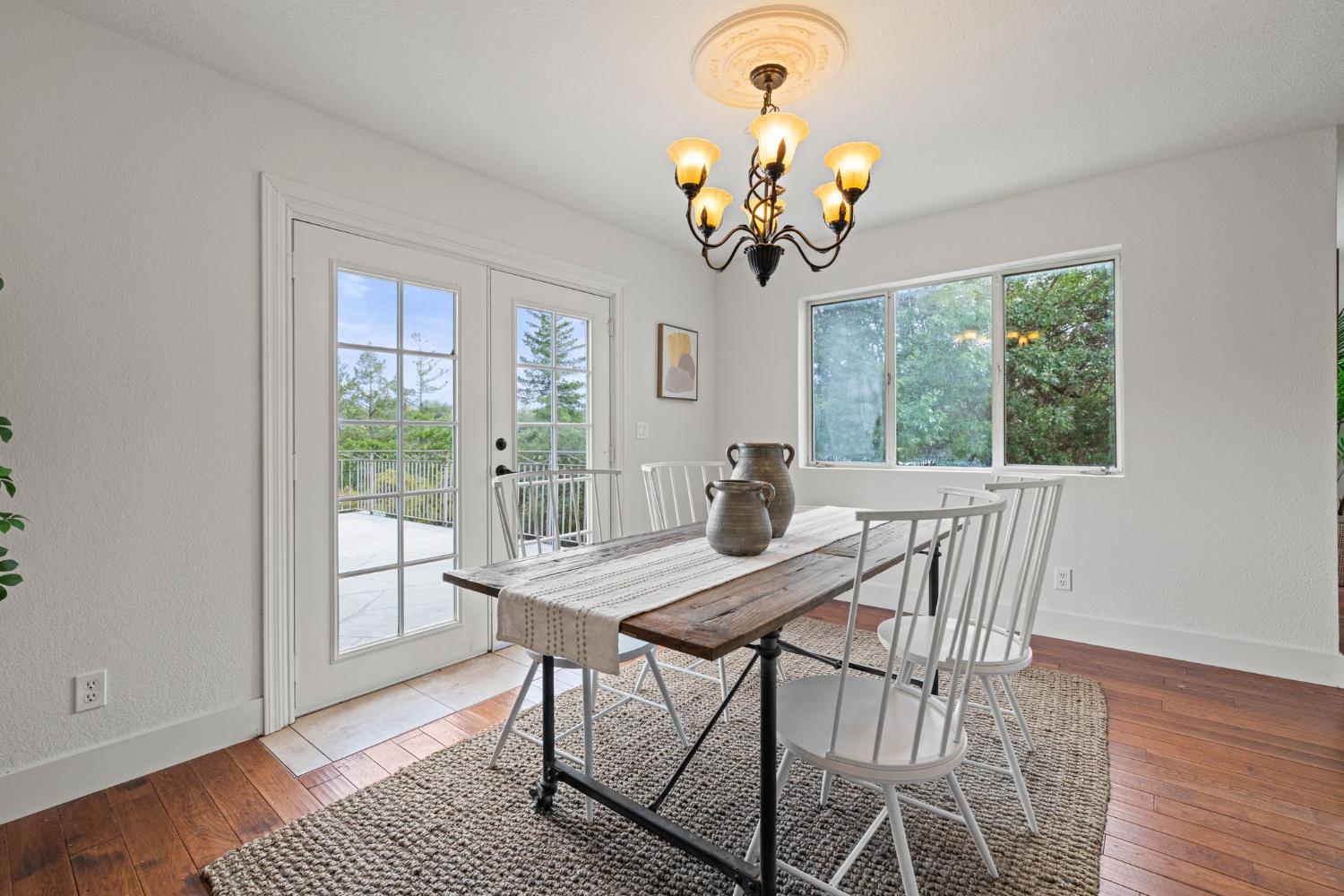 22160 Winchester Way Colfax, CA 95713 - Photo 29 of 84 a view of a dining room with furniture a chandelier and wooden floor