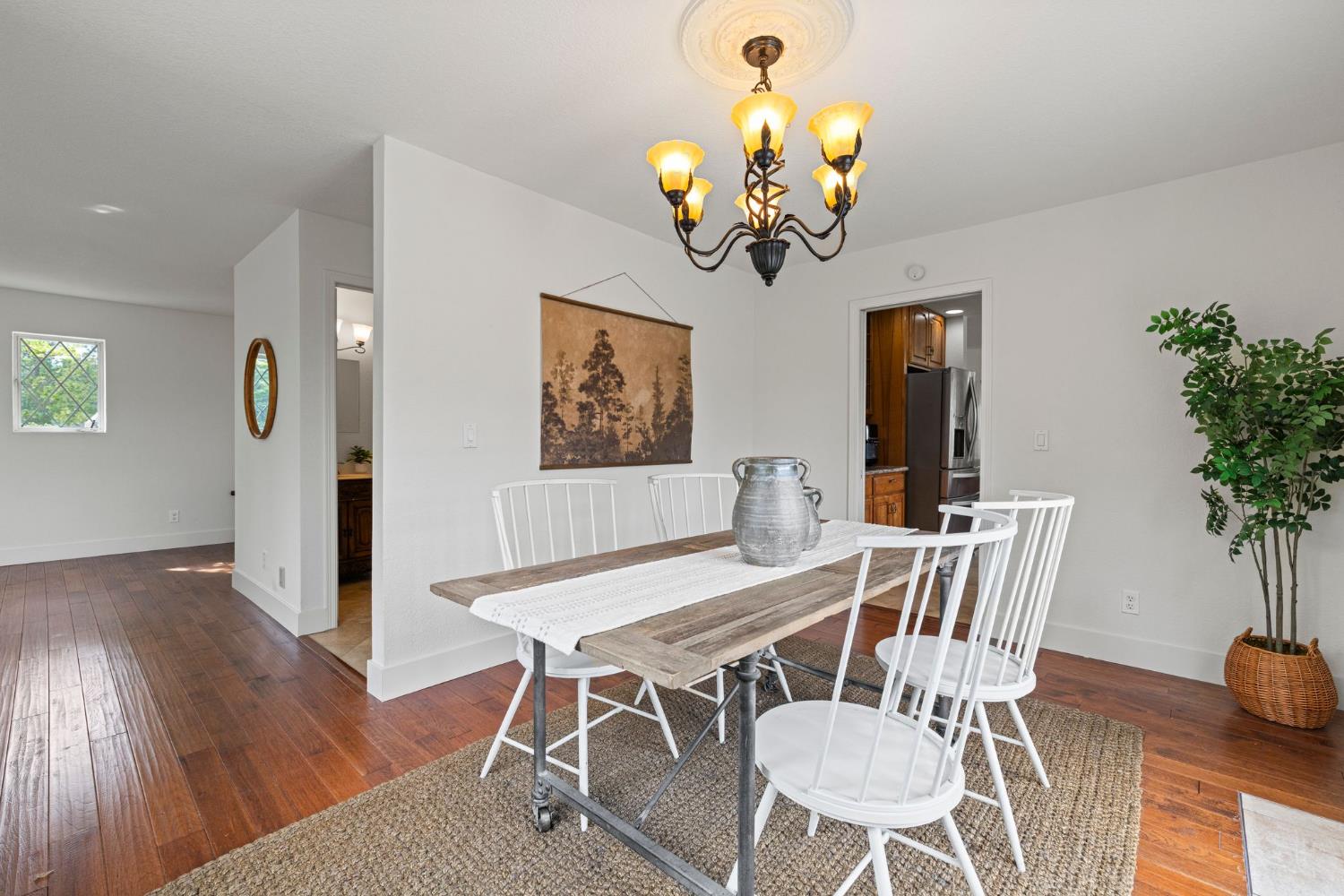 22160 Winchester Way Colfax, CA 95713 - Photo 30 of 84 a view of a dining room with furniture wooden floor and chandelier