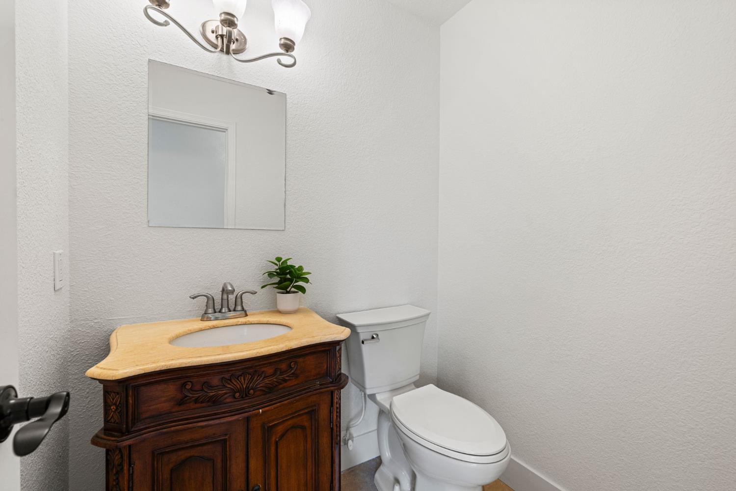 22160 Winchester Way Colfax, CA 95713 - Photo 32 of 84 a bathroom with a sink a toilet and mirror