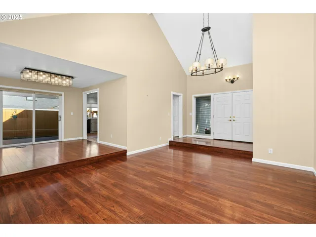 a view of a room with wooden floor and large windows
