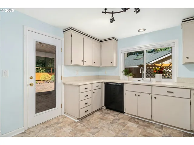 a kitchen with stainless steel appliances granite countertop a sink and cabinets