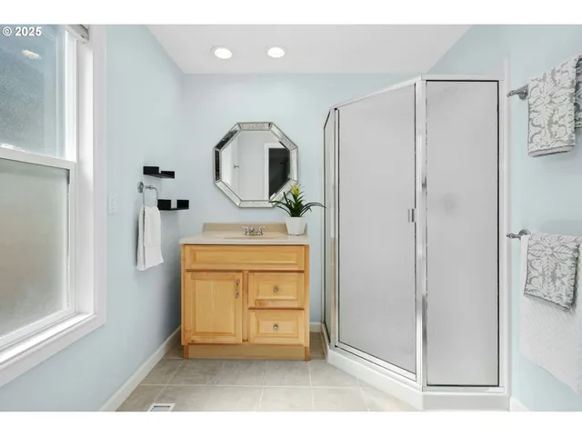 a living room with stainless steel appliances kitchen island a rug and a window
