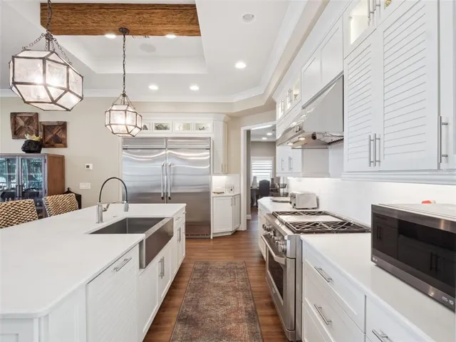 a living room with furniture a fireplace and a ceiling fan