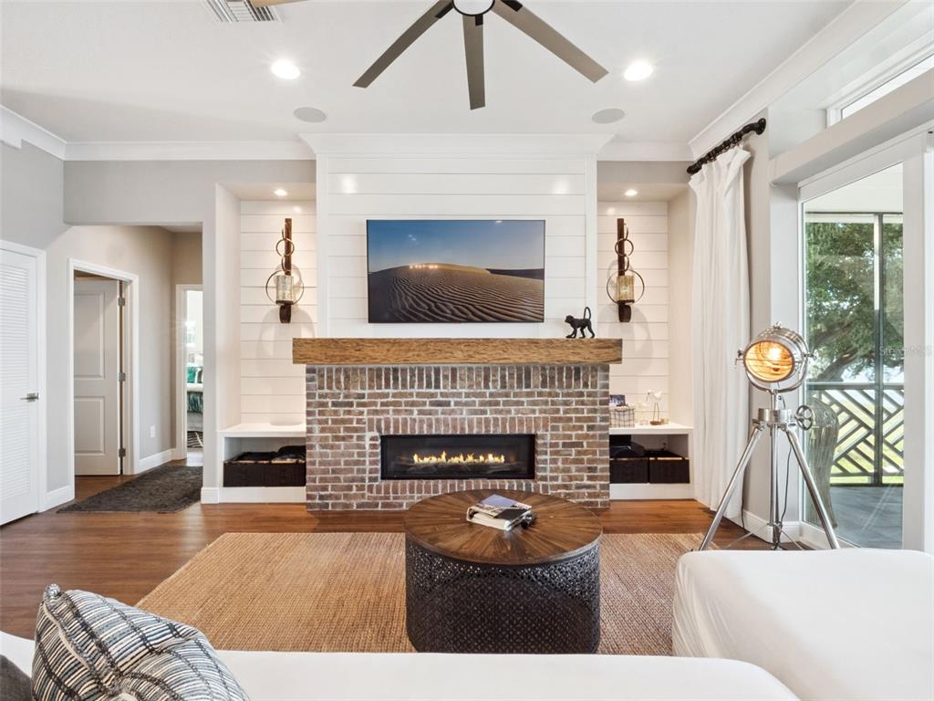 12943 Southeast Sunset Harbor Road Weirsdale, FL 32195 - Photo 23 of 65 a living room with furniture and a fireplace