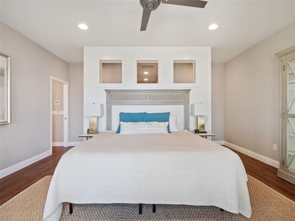 12943 Southeast Sunset Harbor Road Weirsdale, FL 32195 - Photo 26 of 65 a spacious bedroom with a bed and a fireplace