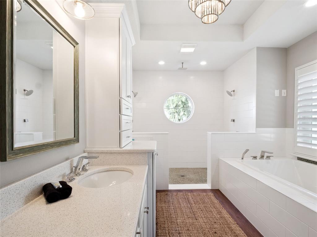 12943 Southeast Sunset Harbor Road Weirsdale, FL 32195 - Photo 27 of 65 a bathroom with a sink a tub and a mirror