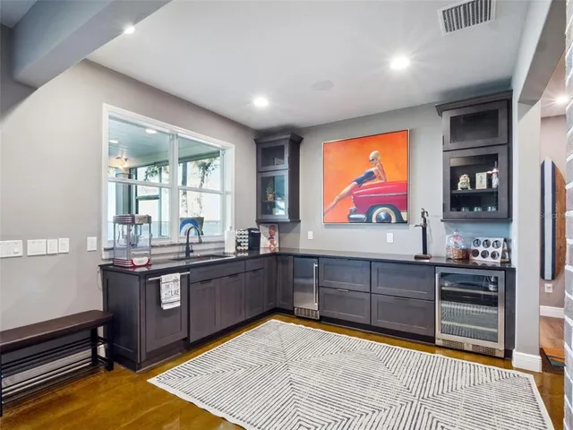 a living room with patio furniture and a floor to ceiling window