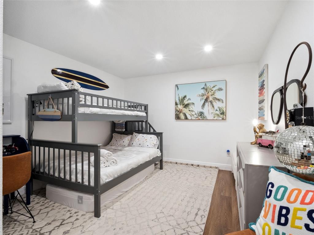 12943 Southeast Sunset Harbor Road Weirsdale, FL 32195 - Photo 44 of 65 a bedroom with furniture and a window