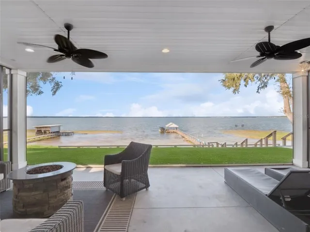 a backyard of a house with lots of green space and lake view