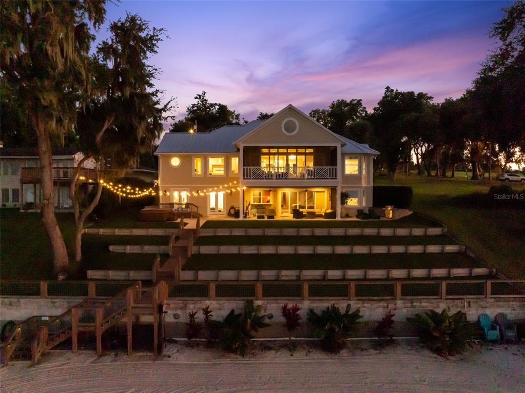 12943 Southeast Sunset Harbor Road Weirsdale, FL 32195 - Photo 6 of 65 a front view of a house with a yard
