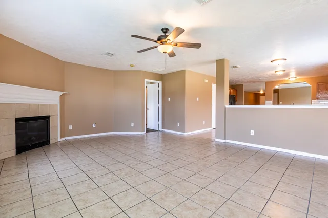 a view of a livingroom with a ceiling fan and window