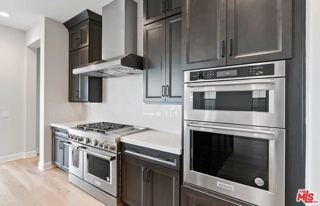 a stove top oven sitting inside of a kitchen