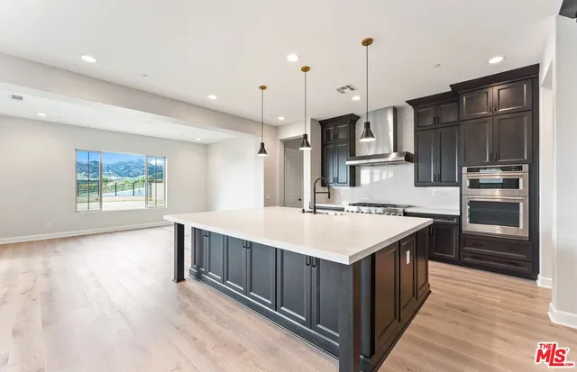 a large kitchen with stainless steel appliances kitchen island a large island in the center