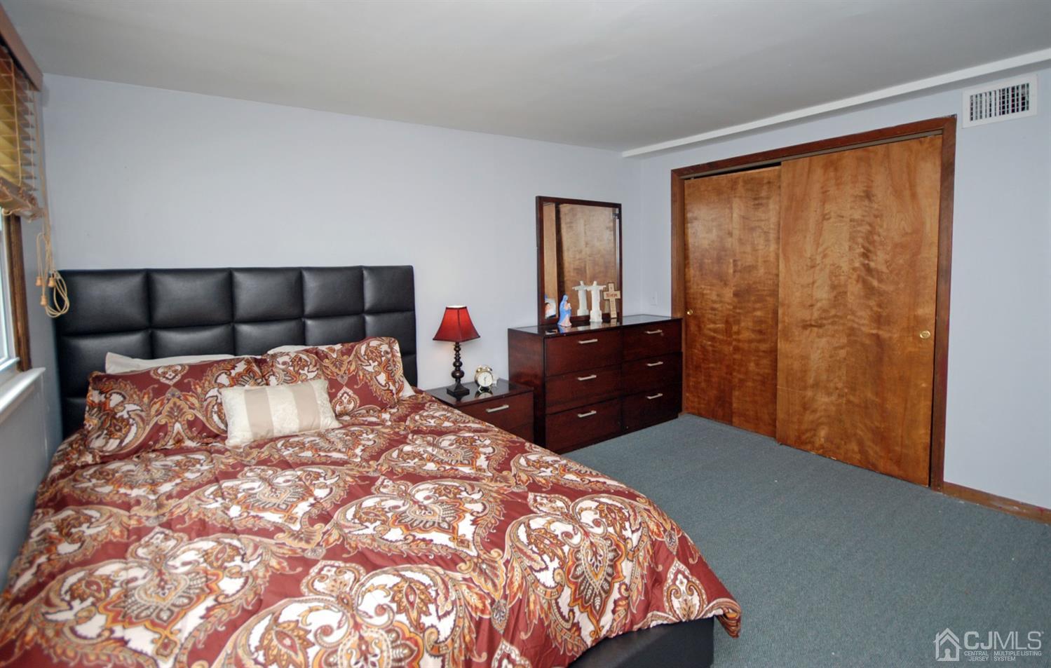 22 Dillon Road Kendall Park, NJ 08824 - Photo 14 of 22 a bed sitting in a bedroom next to a window