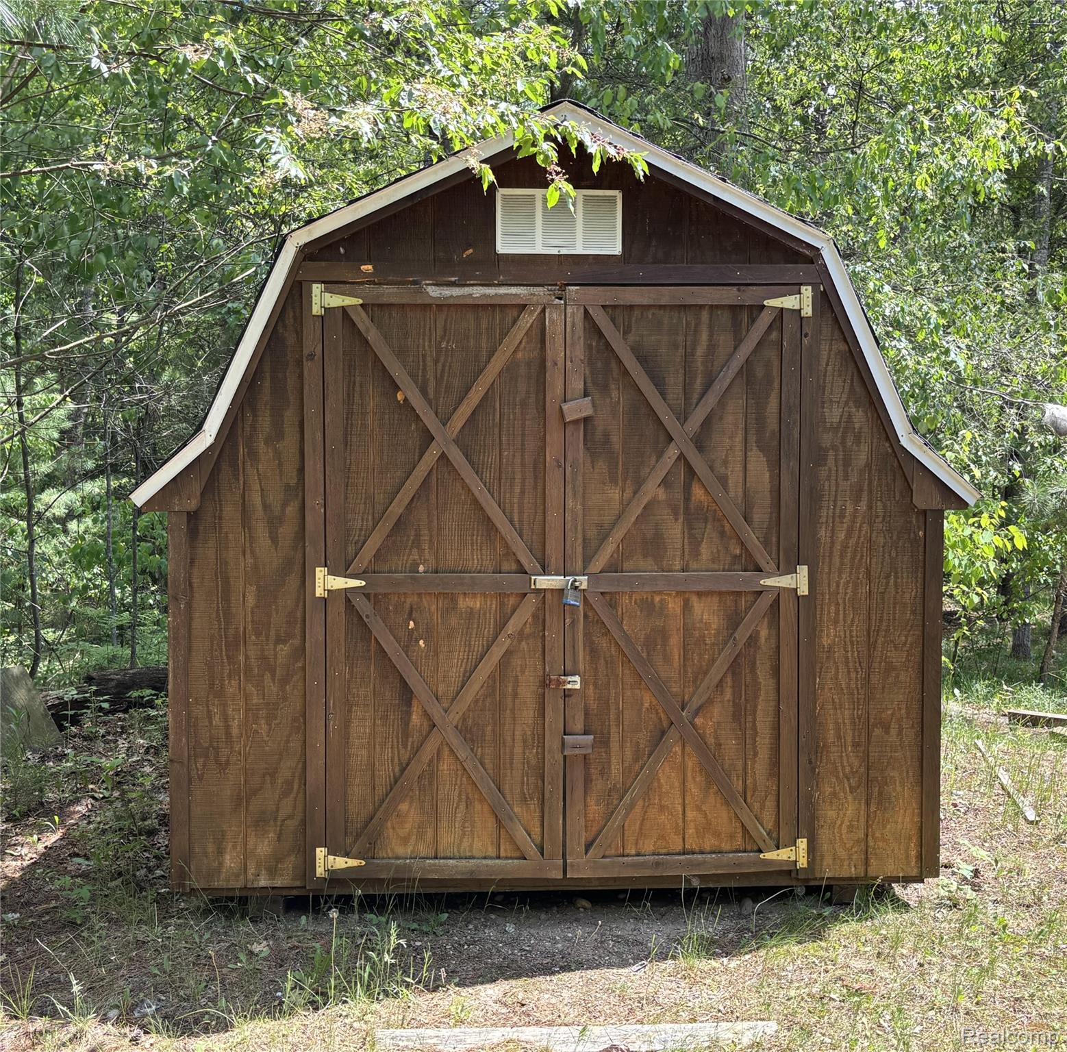 955 Aeronca Road Luzerne, MI 48636 - Photo 7 of 20 Gambrel-roof shed with wood-panel siding and double barn doors