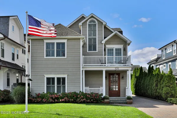 a front view of a house with yard and green space