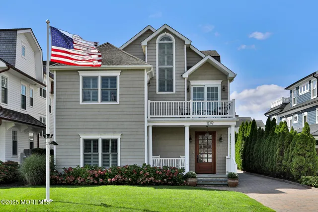 a front view of a house with yard and green space