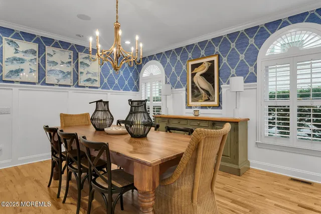 a view of kitchen with stainless steel appliances granite countertop a stove a sink a dining table and chairs