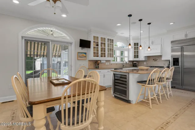 a kitchen with a stove a kitchen island a table and chairs