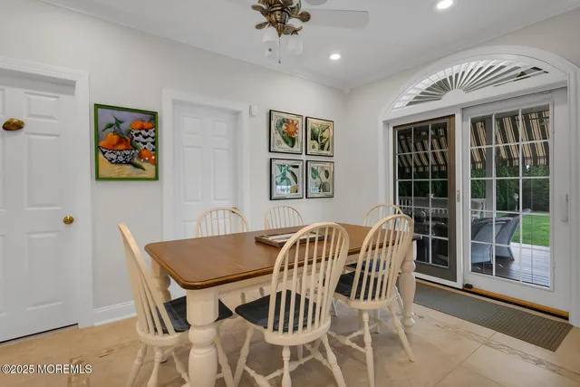 a view of a patio with table and chairs with wooden floor and fence