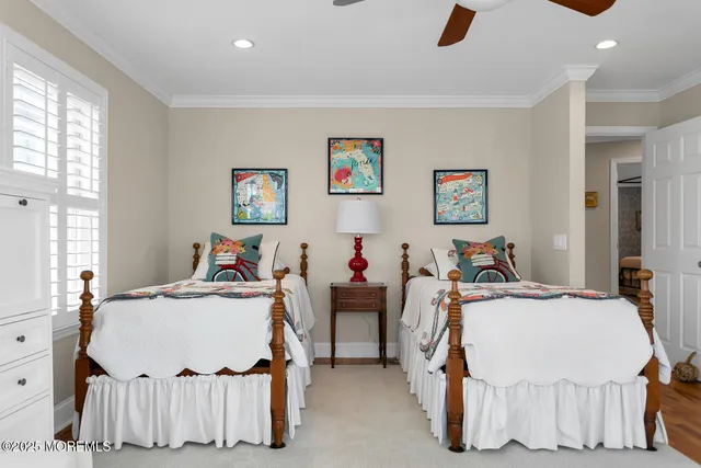 a bedroom with a bed next to a window with cabinet