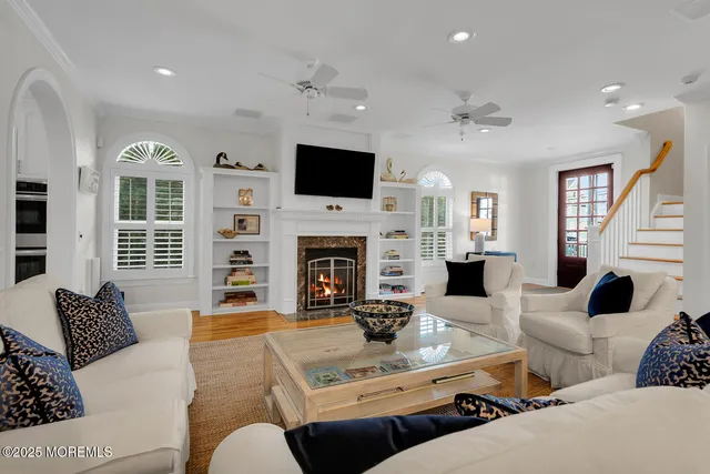 a living room with furniture and a view of kitchen