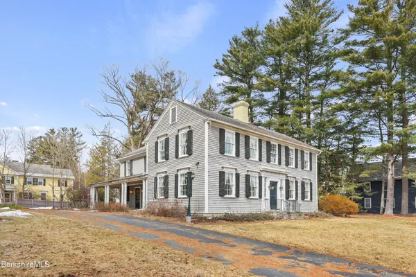 a front view of a building with a garden