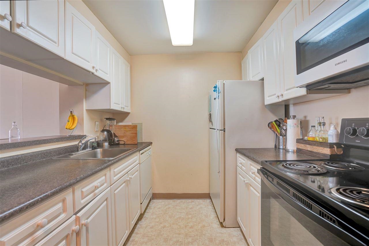 1 2nd Street, Unit 1105 Jersey City, NJ 07302 - Photo 12 of 17 a kitchen with a sink stove and refrigerator