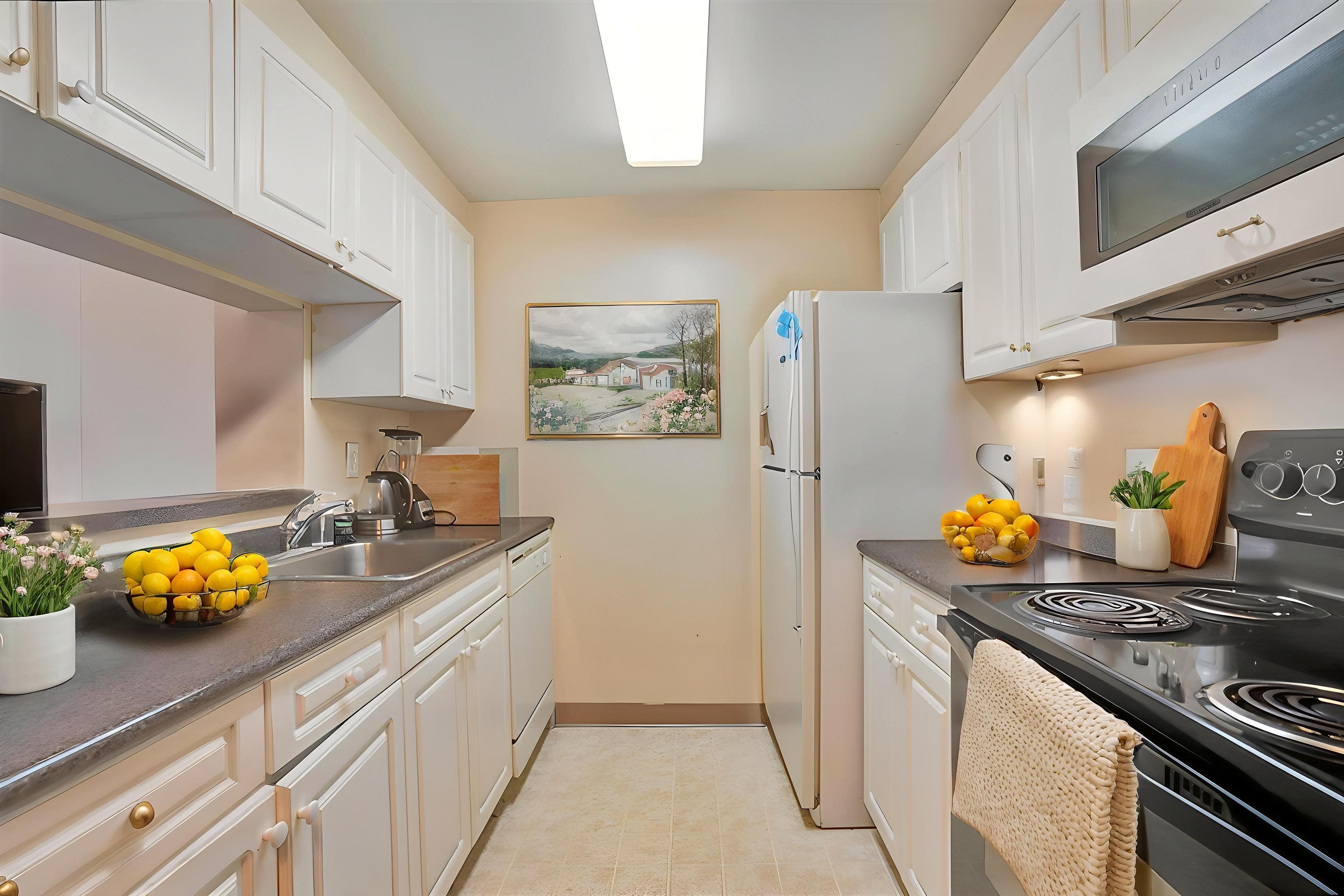 1 2nd Street, Unit 1105 Jersey City, NJ 07302 - Photo 3 of 17 a kitchen with stainless steel appliances a stove a refrigerator and a white cabinets