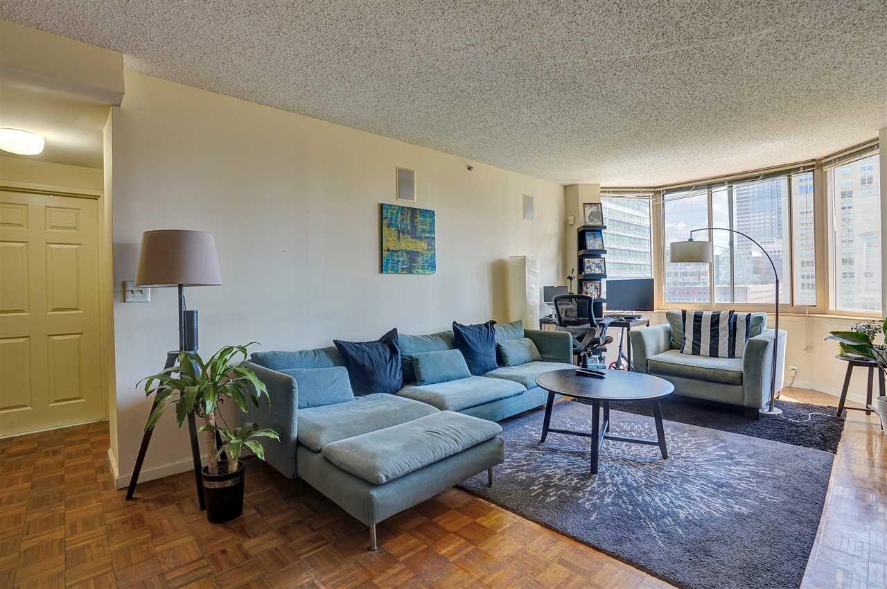 1 2nd Street, Unit 1105 Jersey City, NJ 07302 - Photo 9 of 17 a living room with furniture and a potted plant