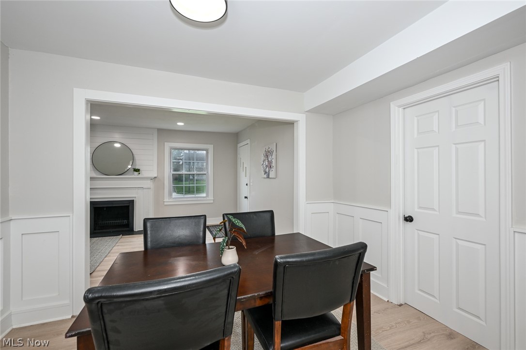 1520 Sheffield Road Cleveland, OH 44121 - Photo 14 of 36 Dining room with light hardwood / wood-style floors and a large fireplace