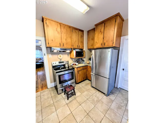 a kitchen with a refrigerator and table