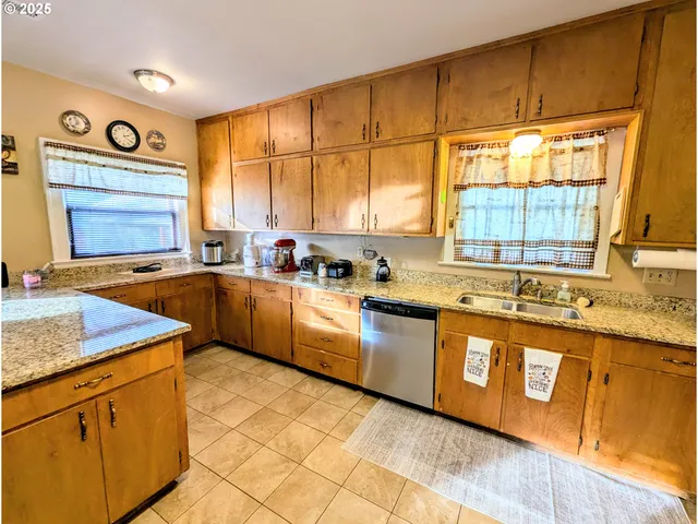 a kitchen with stainless steel appliances granite countertop sink stove and cabinets