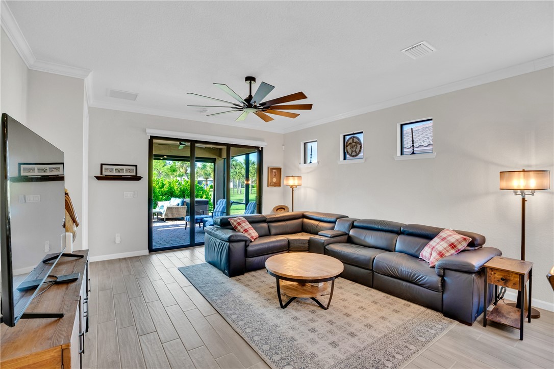 5292 Unity Square Vero Beach, FL 32967 - Photo 12 of 36 a living room with furniture ceiling fan and a window
