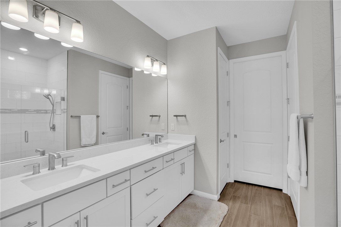 5292 Unity Square Vero Beach, FL 32967 - Photo 17 of 36 a spacious bathroom with a double vanity sink a mirror and a shower