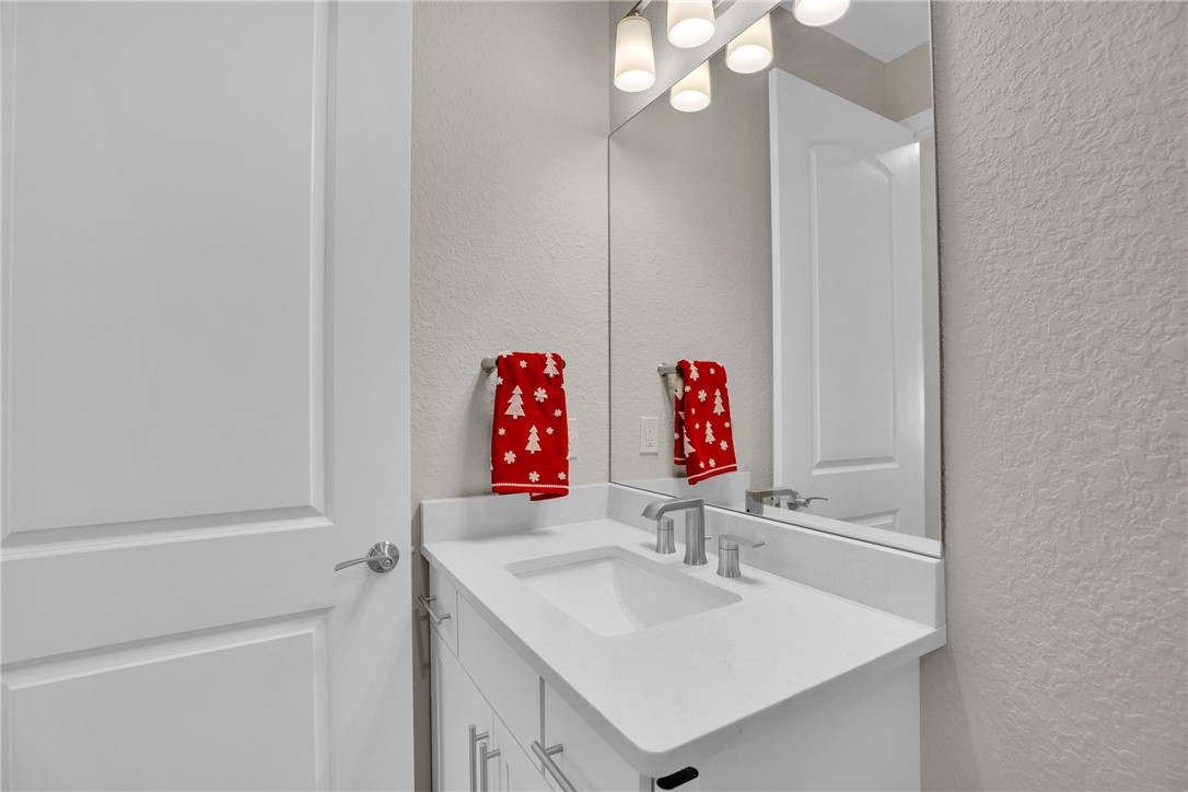 5292 Unity Square Vero Beach, FL 32967 - Photo 20 of 36 a bathroom with a sink vanity and a mirror