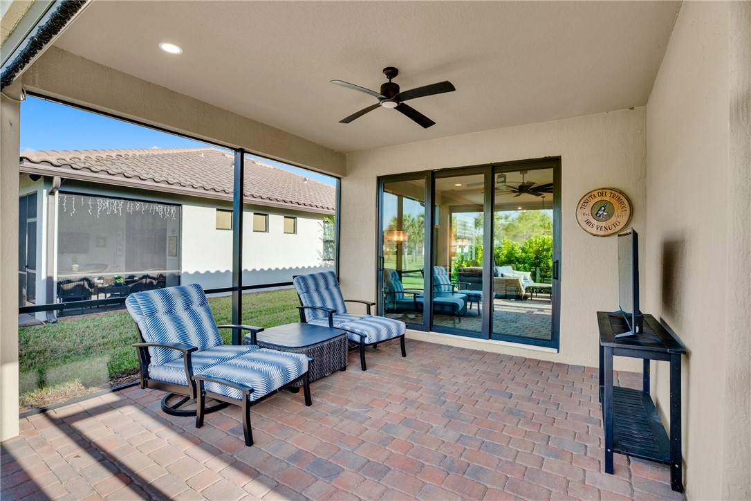 5292 Unity Square Vero Beach, FL 32967 - Photo 27 of 36 a living room with furniture a ceiling fan and a large window