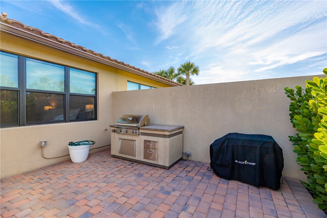 5292 Unity Square Vero Beach, FL 32967 - Photo 30 of 36 a white stove top oven sitting in a backyard