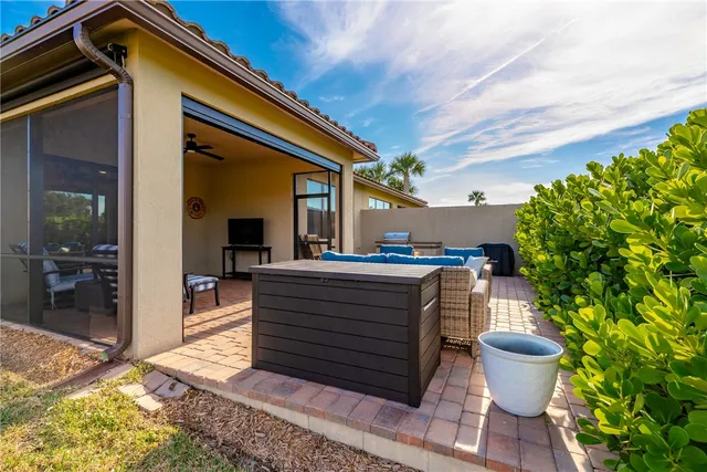 an aerial view of a house with a yard and outdoor seating