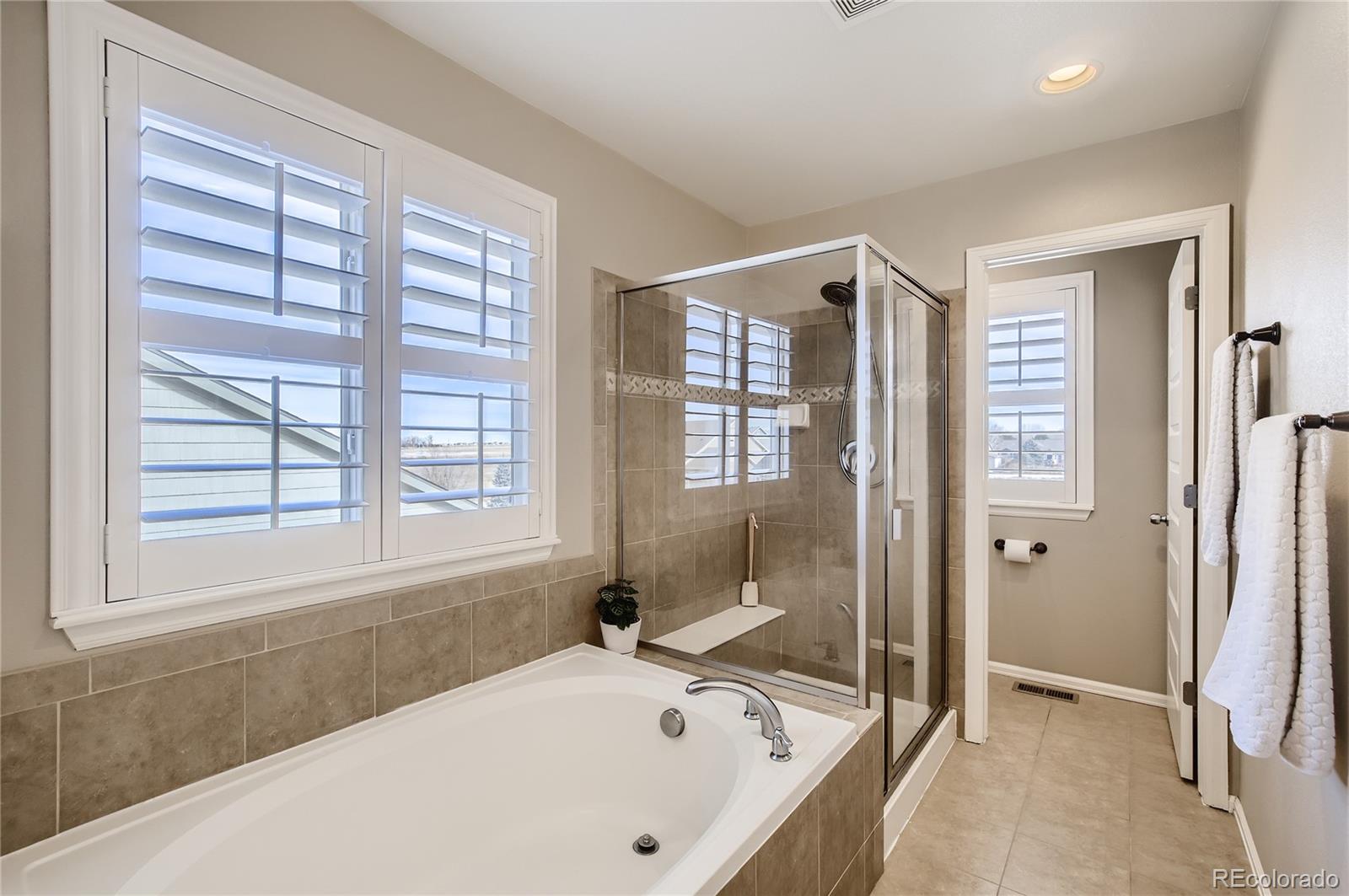 8314 Raspberry Drive Frederick, CO 80504 - Photo 18 of 31 a bathroom with a bathtub and a shower
