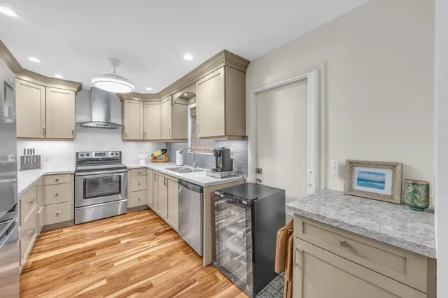 a kitchen with granite countertop white cabinets and white appliances