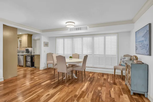 a view of a dining room with furniture and wooden floor