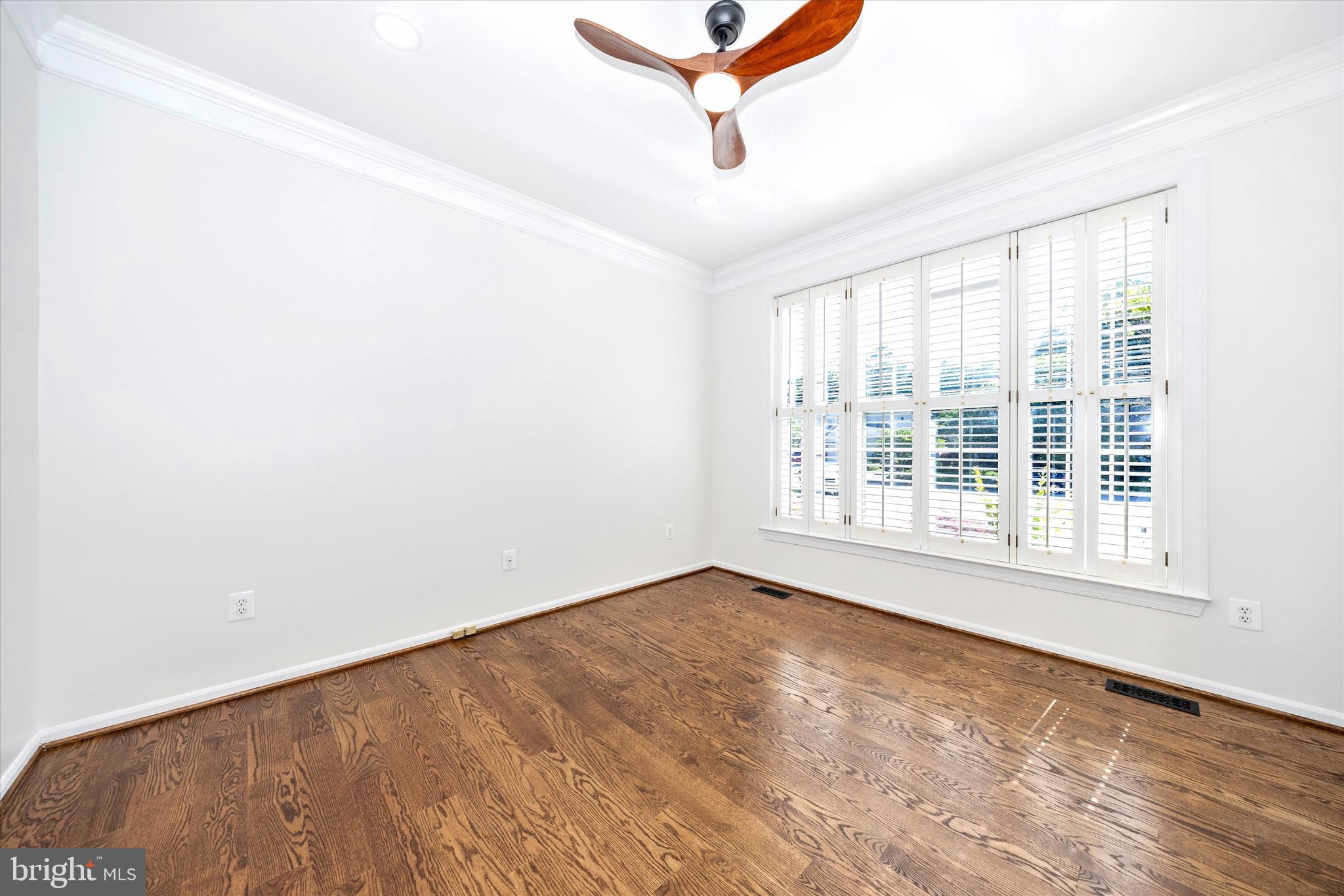 803 Apache Court Frederick, MD 21701 - Photo 5 of 46 an empty room with wooden floor fan and windows