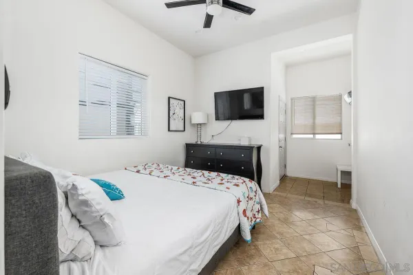 a bedroom with a bed and a flat screen tv