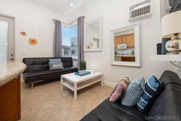 a living room with furniture and a potted plant