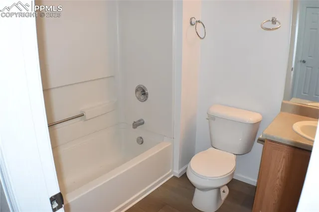 a white toilet sitting next to a bath tub