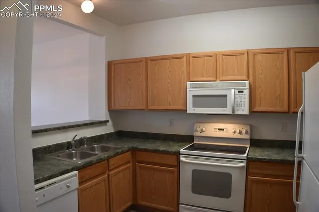 a kitchen with stainless steel appliances granite countertop a sink stove and microwave